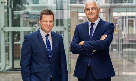 Photograph of Jamie Olden and Richard Martin outside an office building