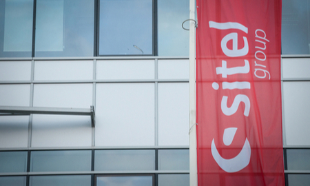 Sitel name and logo on a flag outside an office building