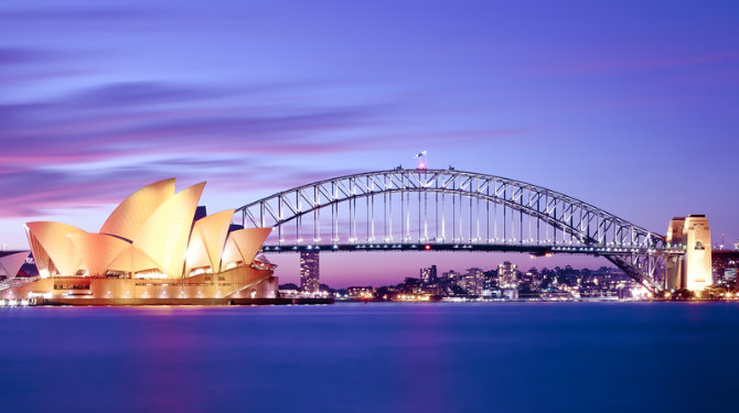 A view of Sydney Opera House and Sydney Harbour Bridge at dusk