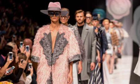 A photo of a fashion show with models walking down the catwalk