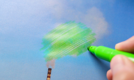 Man painting green pollution from a chimney