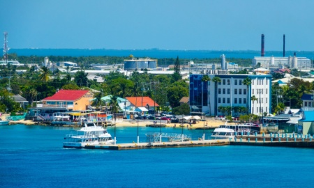 George Town, Grand Cayman Island, UK Street view of George Town at day with pedestrians near tourist shops in downtown of George Town a cruise ship destination. Created 04.02.23