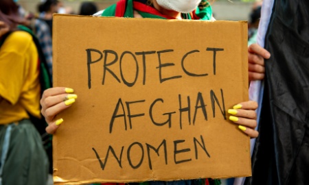 New Delhi, India-Aug 24 2021: Afghan student crying while protesting with placards against the Taliban demanding protect afghan women, protest organised by National Federation of Indian Women